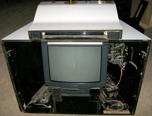 Arcade cabinet glowing in a dark room